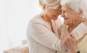 Photo of two smiling senior women embracing